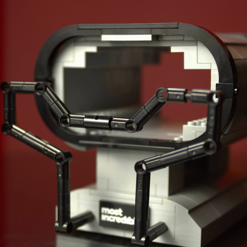 Close-up of a mechanical model with a red background made of lego