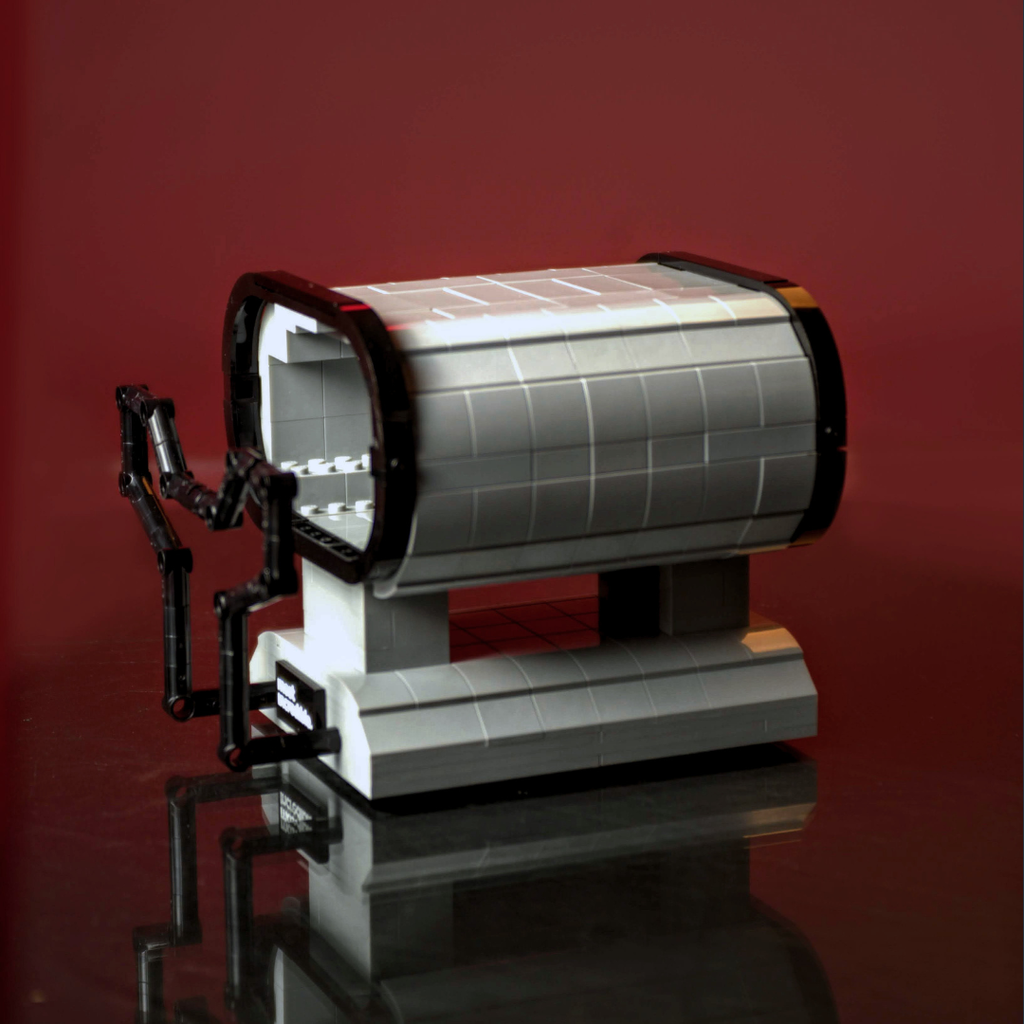 Model of a vintage hot stove and comb on a reflective surface with a red background made of lego